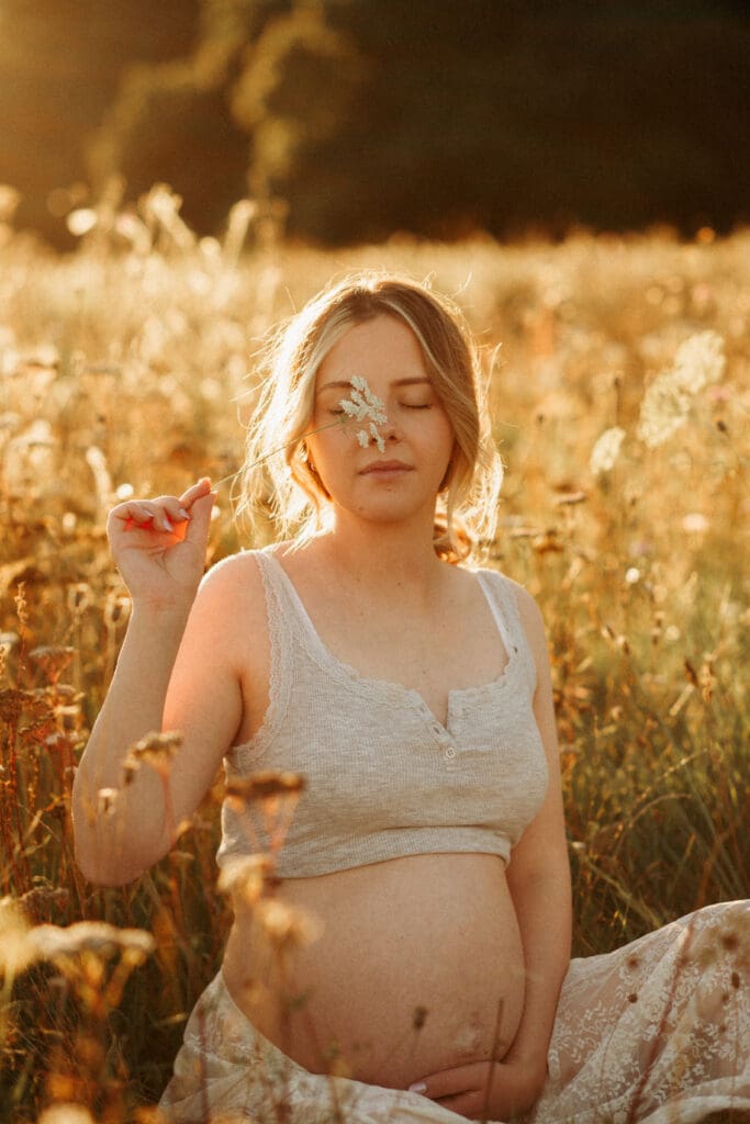 Maternity photoshoot in a flower meadow during sunset in Christchurch